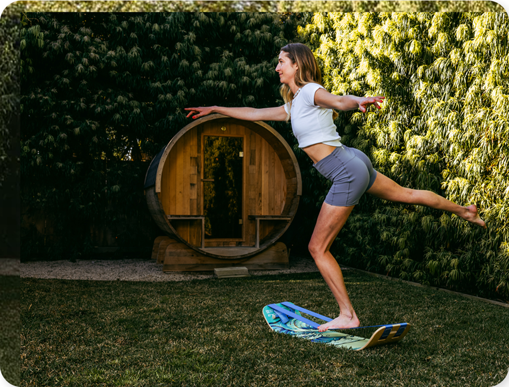 Woman balancing on a SlackBoard Plus in her garden