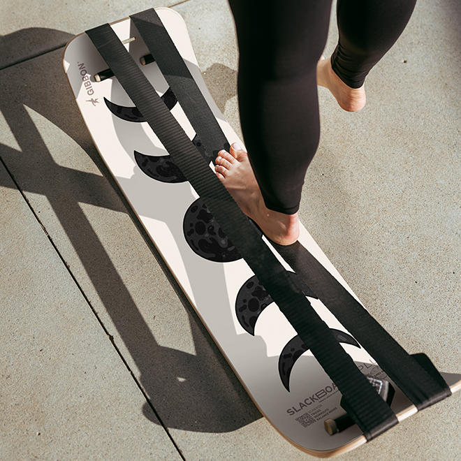 Person using a Moon Slackboard Plus on a concrete surface